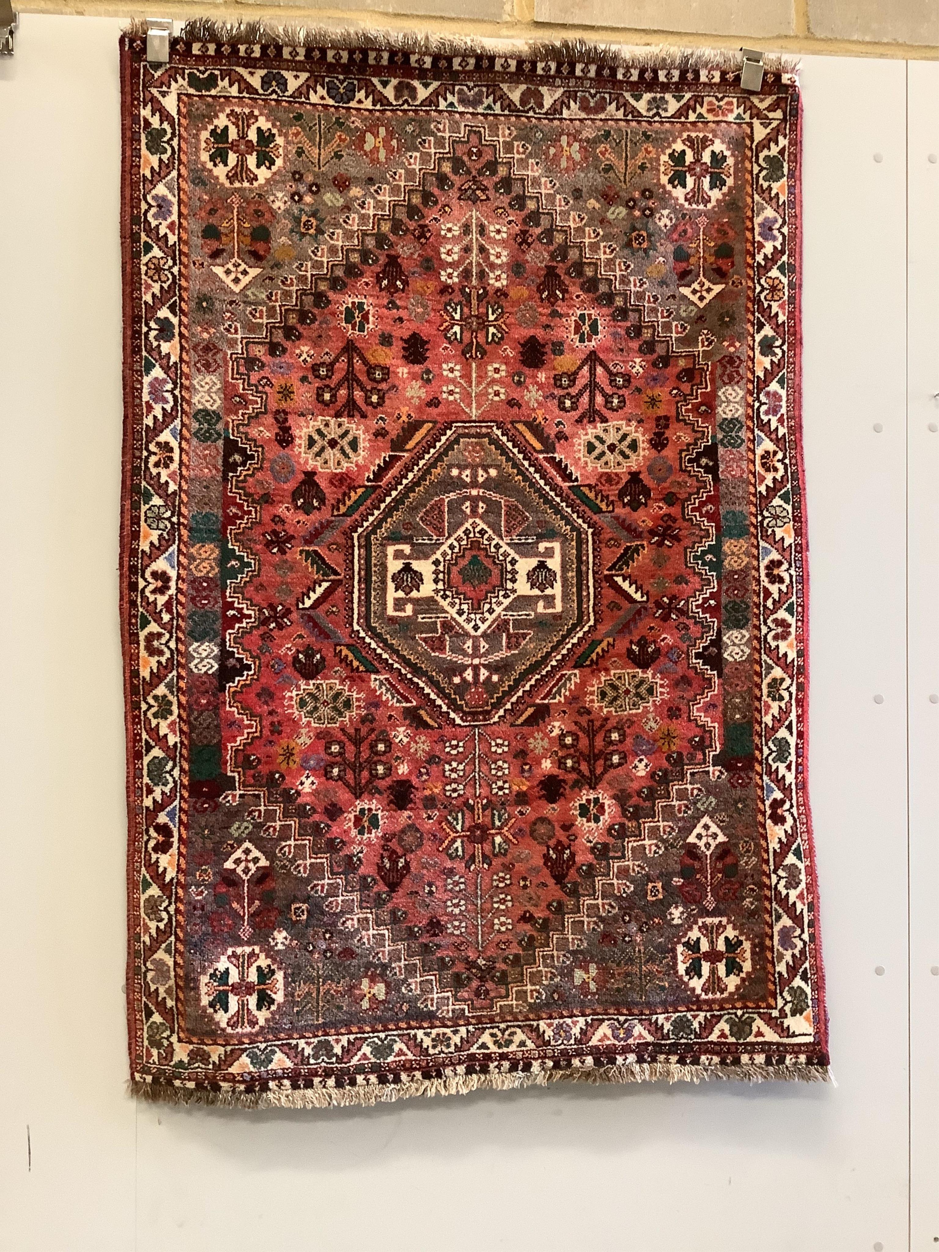 A North West Persian brick red ground rug, 158 x 109cm
